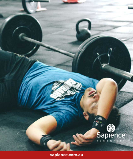 man laying on floor in a gym