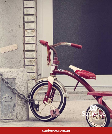 red bicycle chained to lamp pole