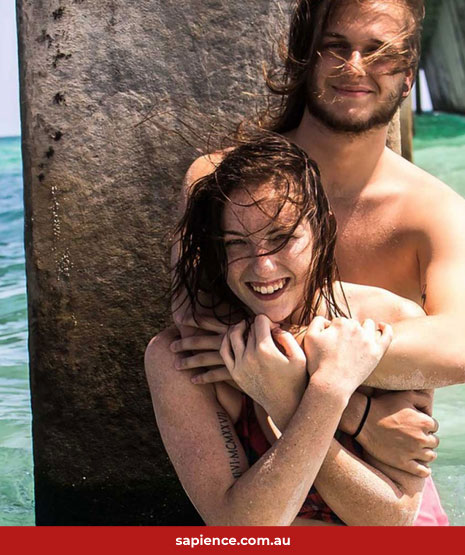 man hugging girl standing in water