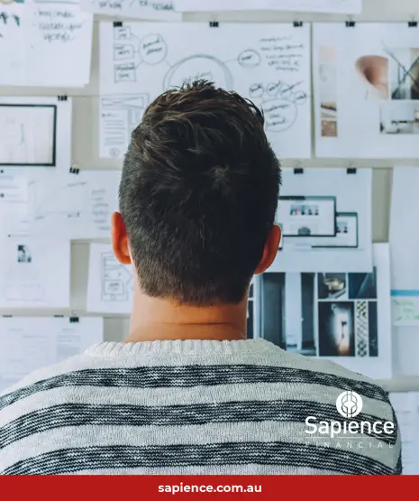 business owner looking at wall of numbers and charts