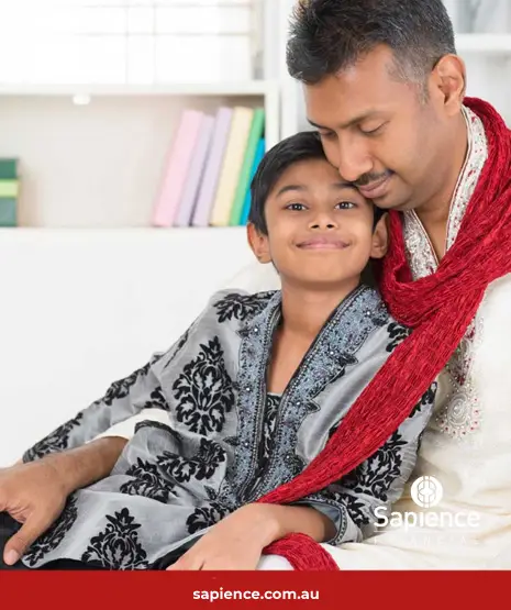 proud Indian father and happily son sitting on his lap