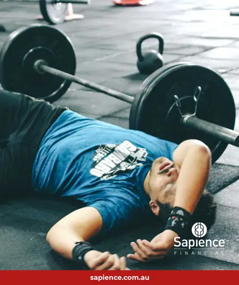 man laying on floor in a gym