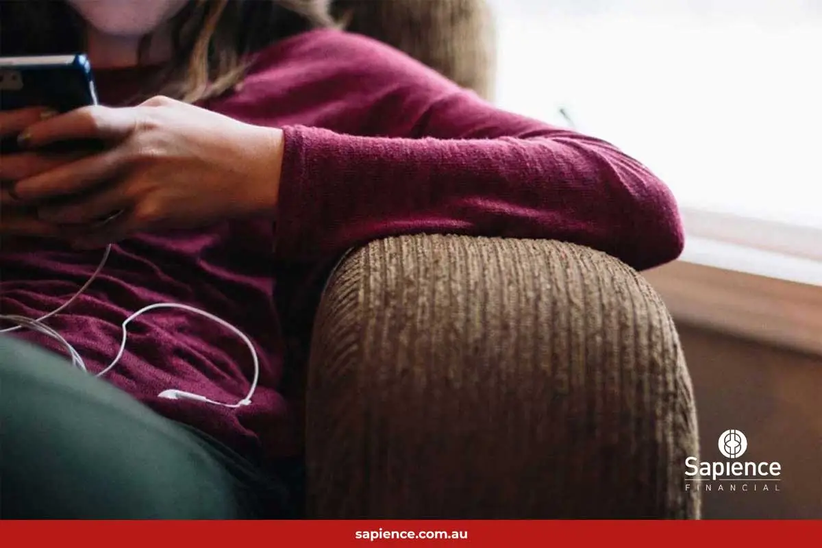 person sitting on sofa listening to music